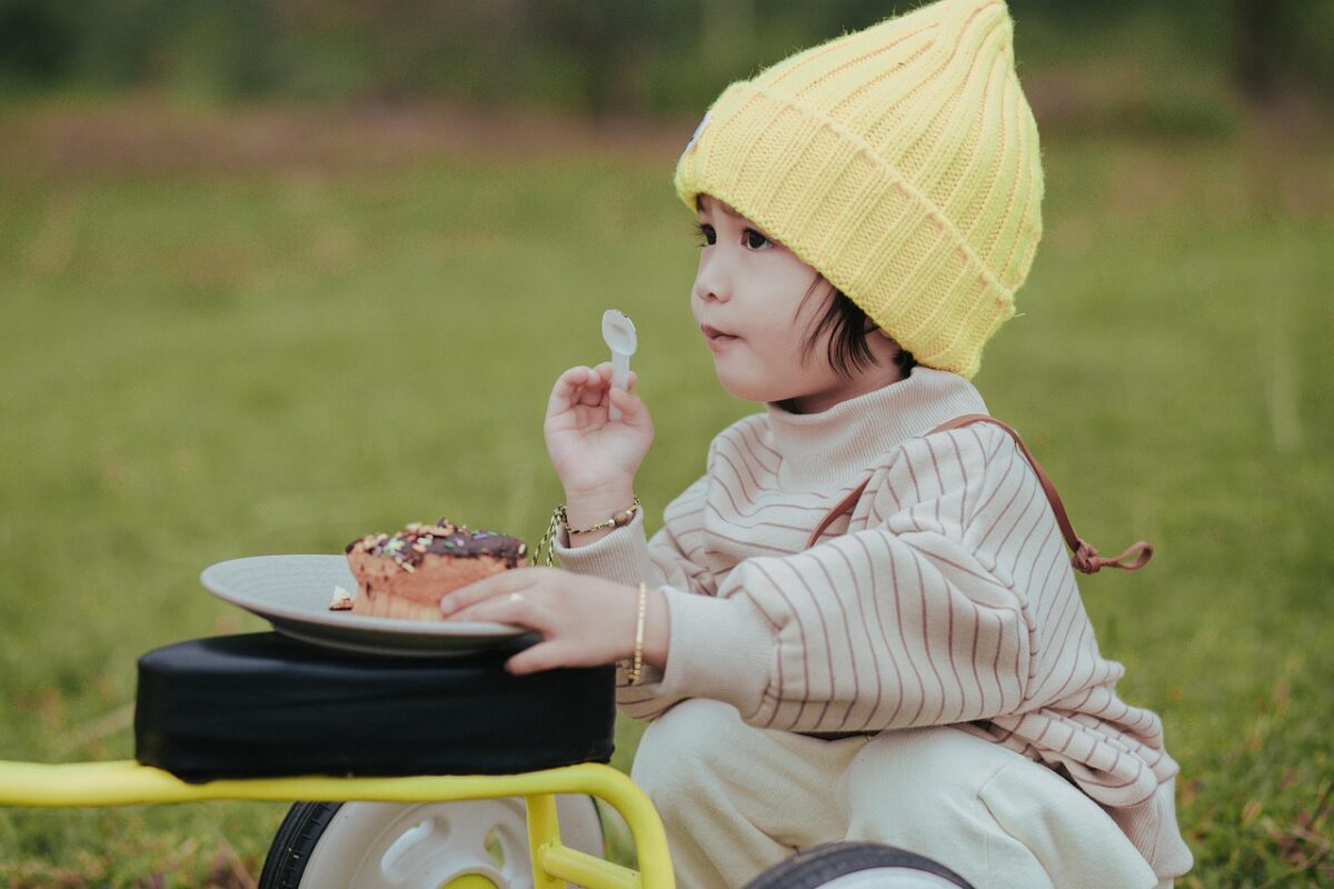 Baby in a high chair wearing a feeding bib