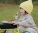 Baby in a high chair wearing a feeding bib